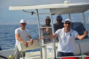 Maximiliano Ricci, a destra, in barca con altri membri della A.S.D. Top Anglers, società organizzatrice della Triathlon Fishing Cup