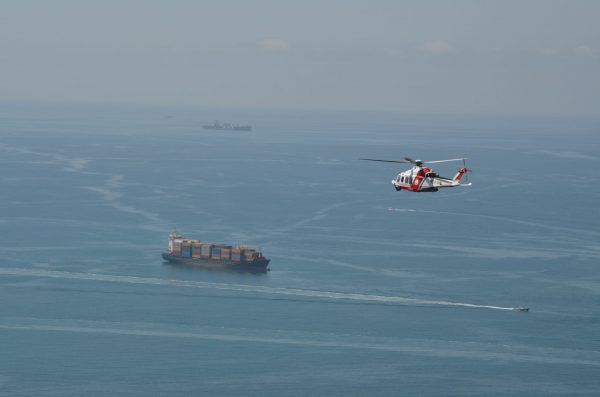 Un elicottero della Guardia Costiera monitora una portacontainer