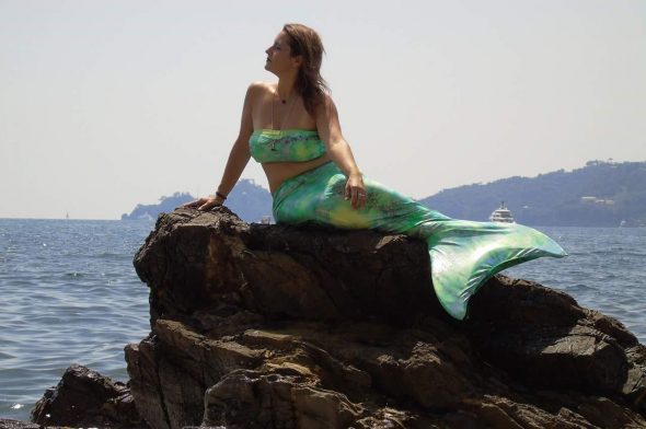 una delle pose sugli scogli che possono far parte di un corso di mermaiding a Rapallo